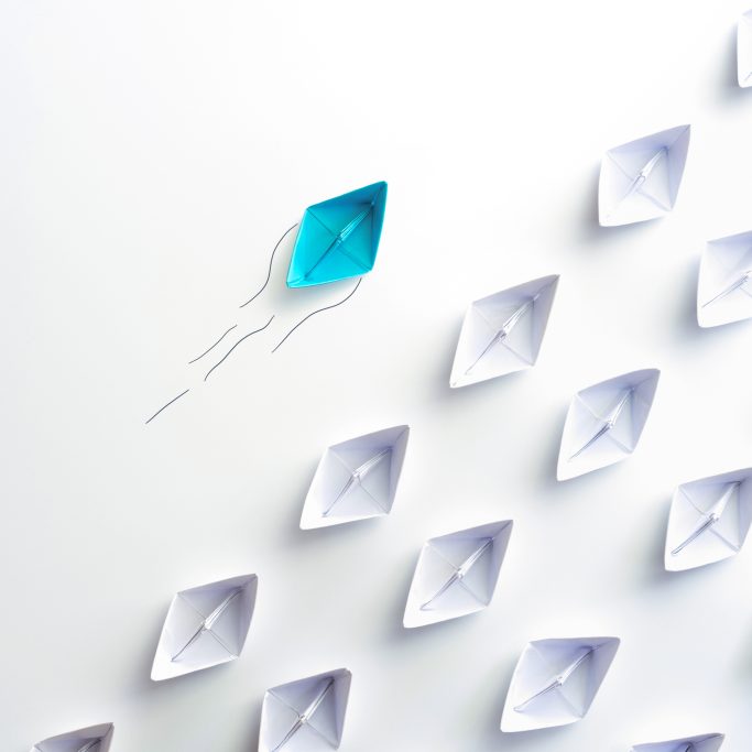 Blue paper ship are different from others and group of paper ships in one direction. Business for Innovative, solution concepts.